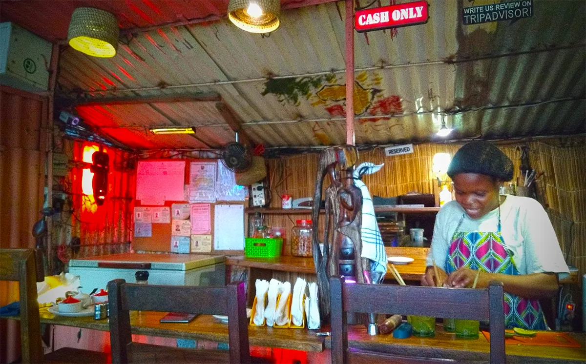 Re Woman preparing food in a restaurant in Tofo Beach Mozambique